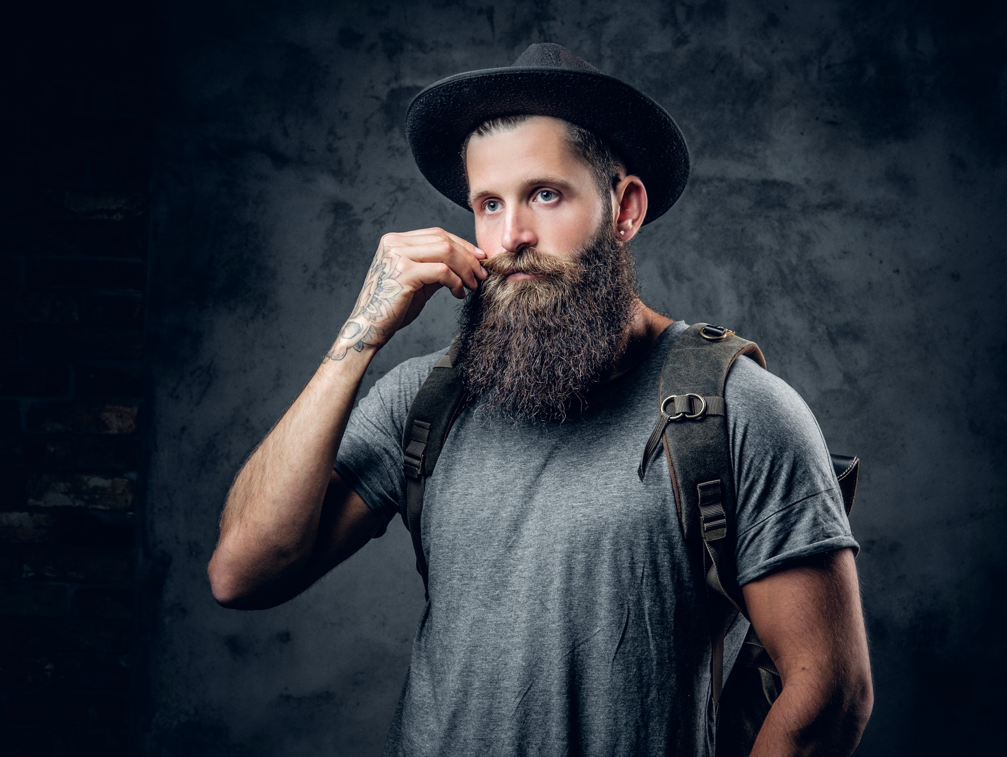 bearded-tattooed-male-in-a-hat